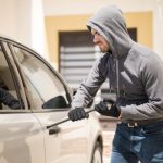 Burglar forcing a car door